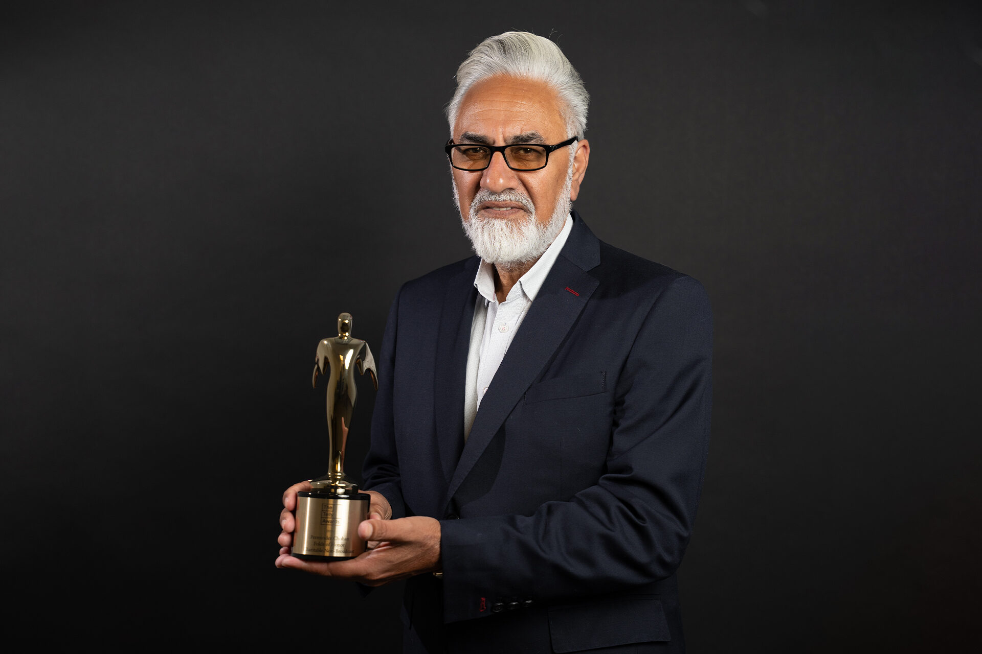 Perminder Chohan holding an award