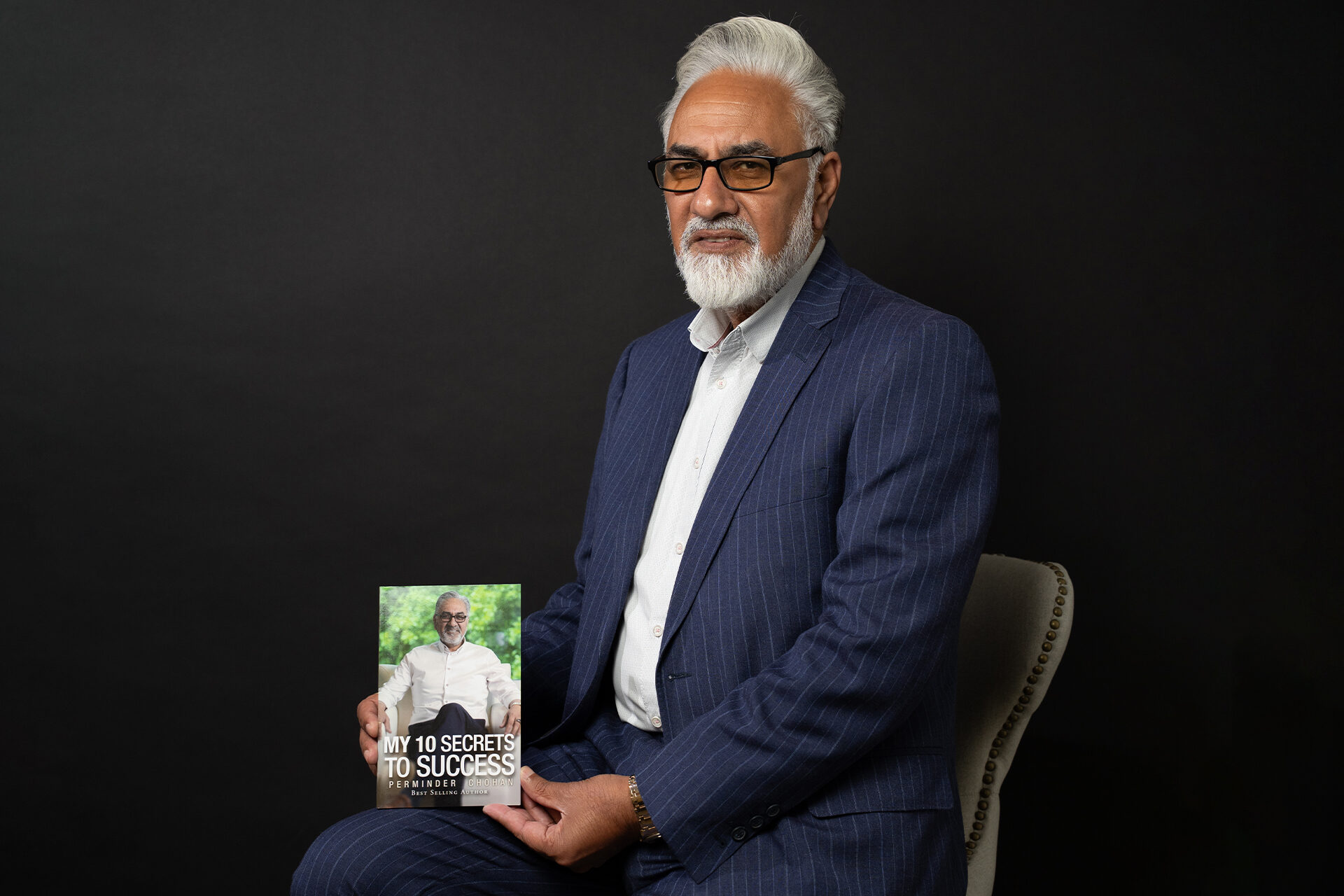 Perminder Chohan holding his book My 10 Secrets to Success